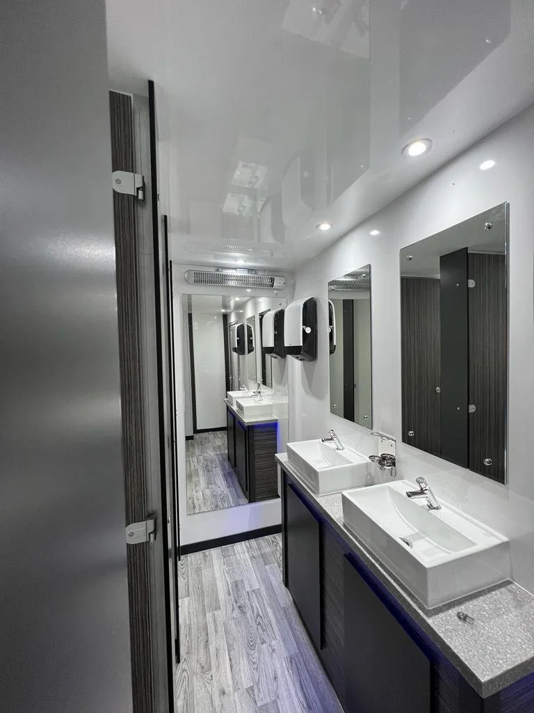 Individual toilet cubicle with walnut door in luxury wedding trailer