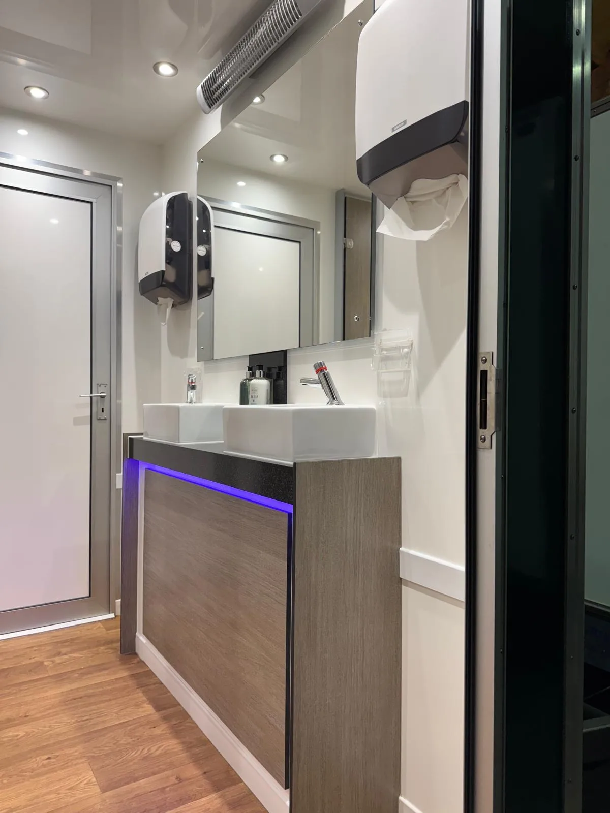 2+1 mains luxury toilet trailer twin square basins on dark wood vanity with blue LED accent lighting